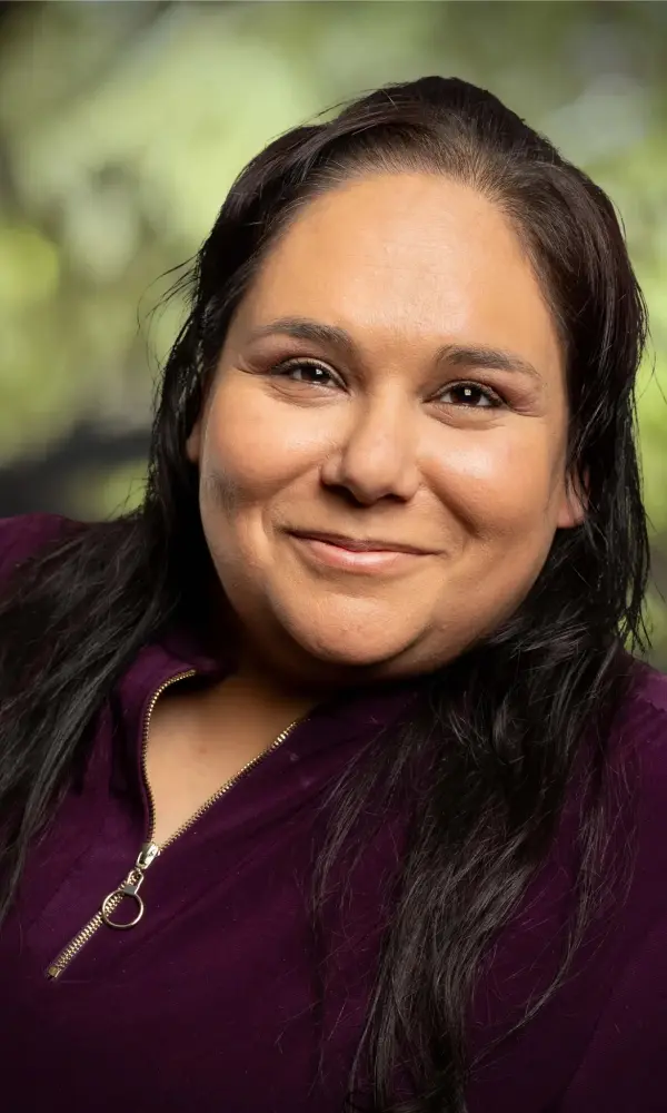 1743792365_annettecanva Smiling woman with dark hair and blouse.