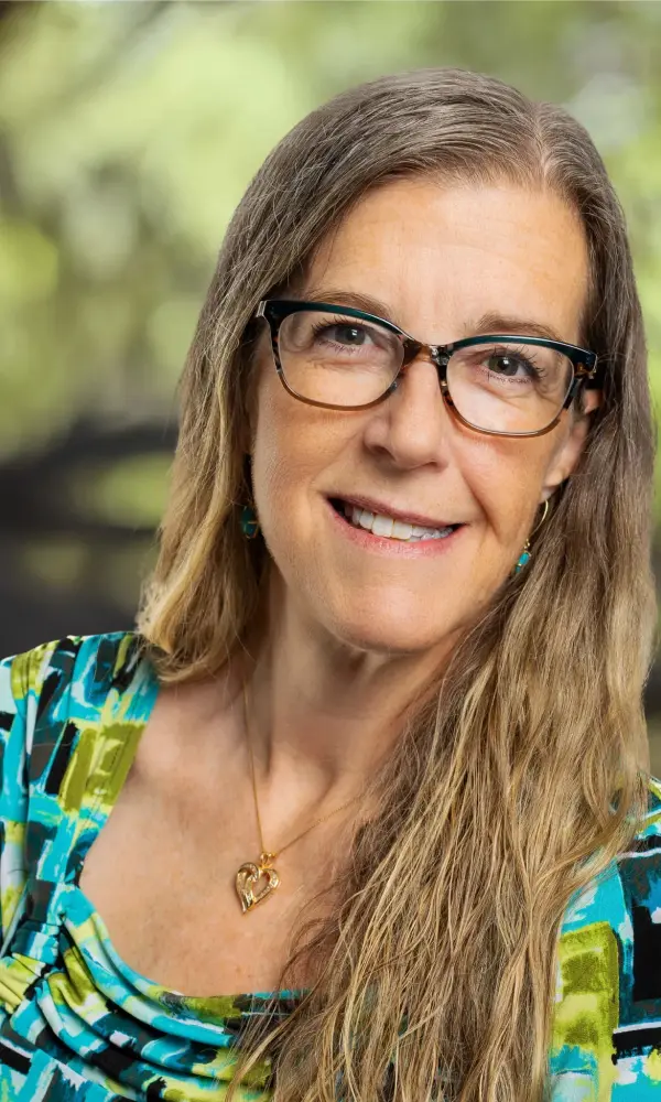 1743792484_webamydawn Woman smiling with glasses and long hair.