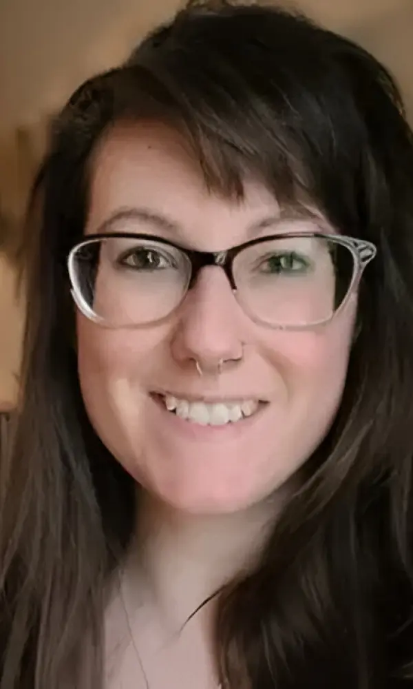 1743792712_Tarren Woman smiling, wearing glasses and nose ring.