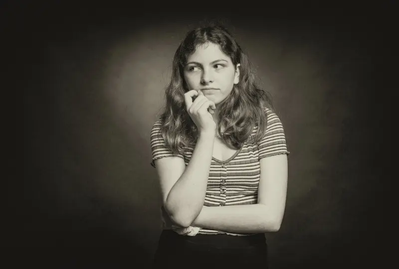 gg 02 Woman in striped shirt, thoughtful expression, monochrome.