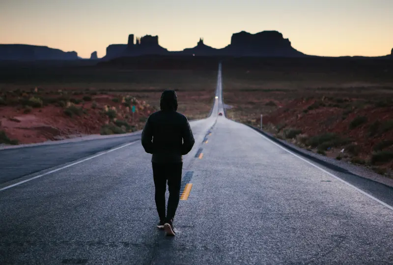 gg 03 Person walking on a deserted road, sunset.