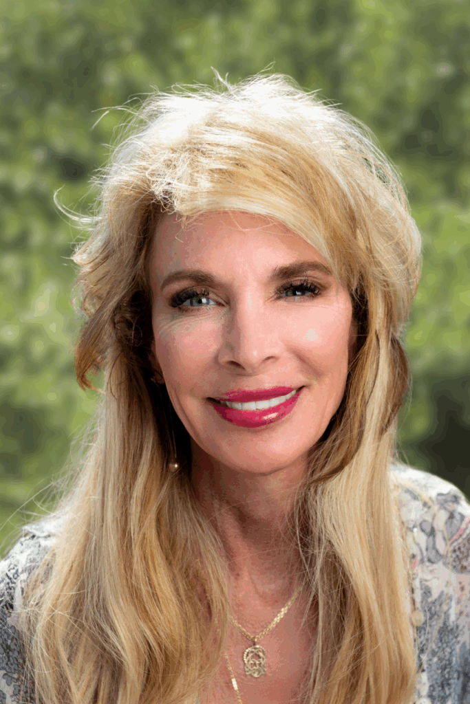 Portrait of a smiling blonde woman outdoors.