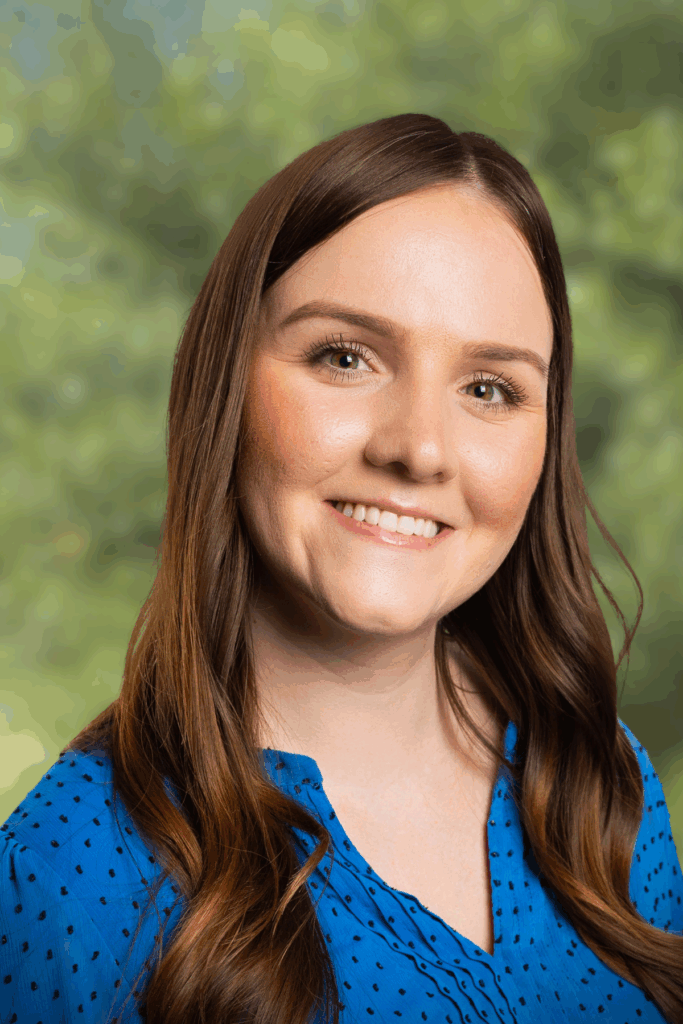 Smiling young woman with brown hair and natural makeup.