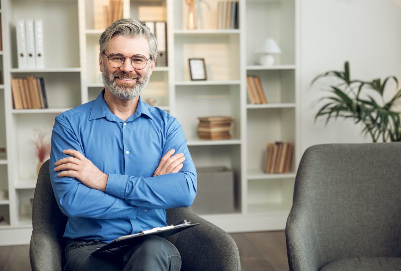 Smiling man sitting in a modern office.